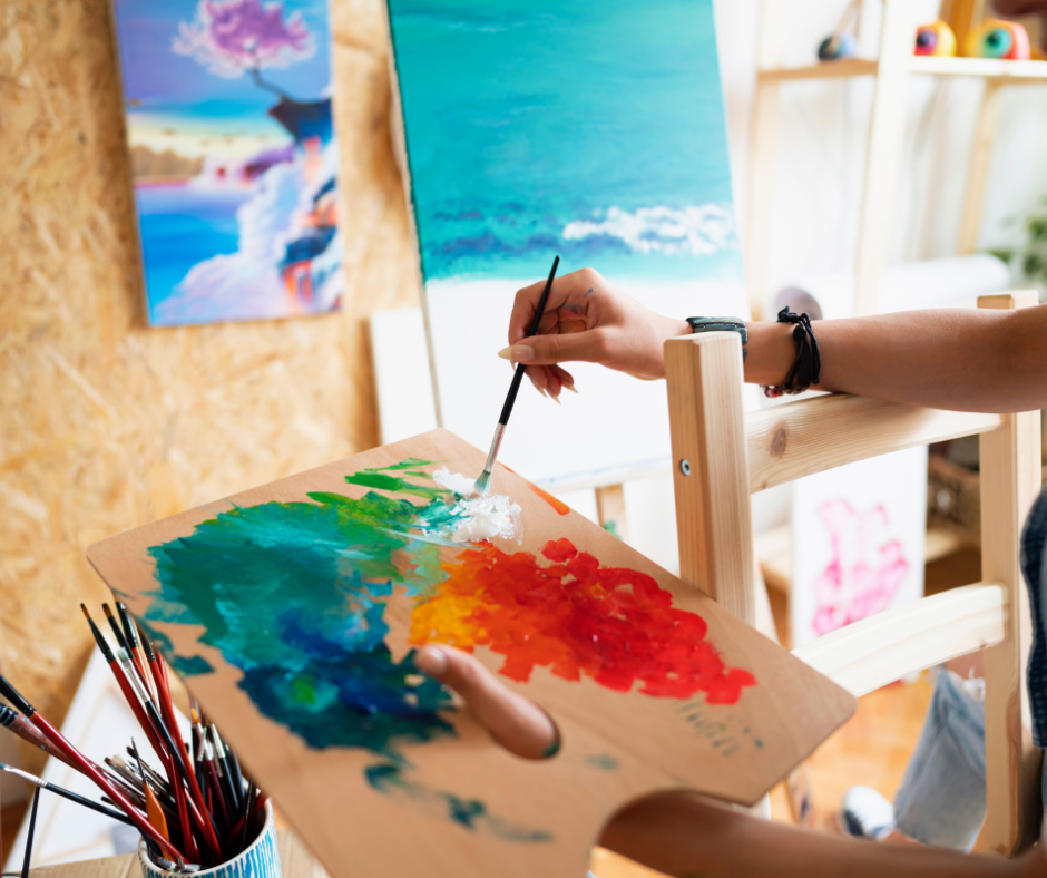 person painting, showing mental health and creativity